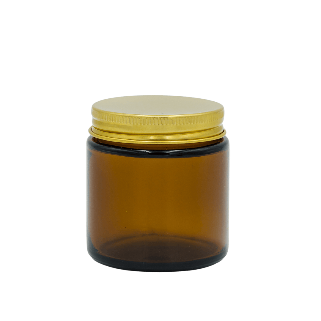 small amber apothecary style candle jar with gold lid