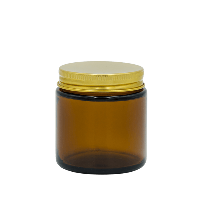 small amber apothecary style candle jar with gold lid