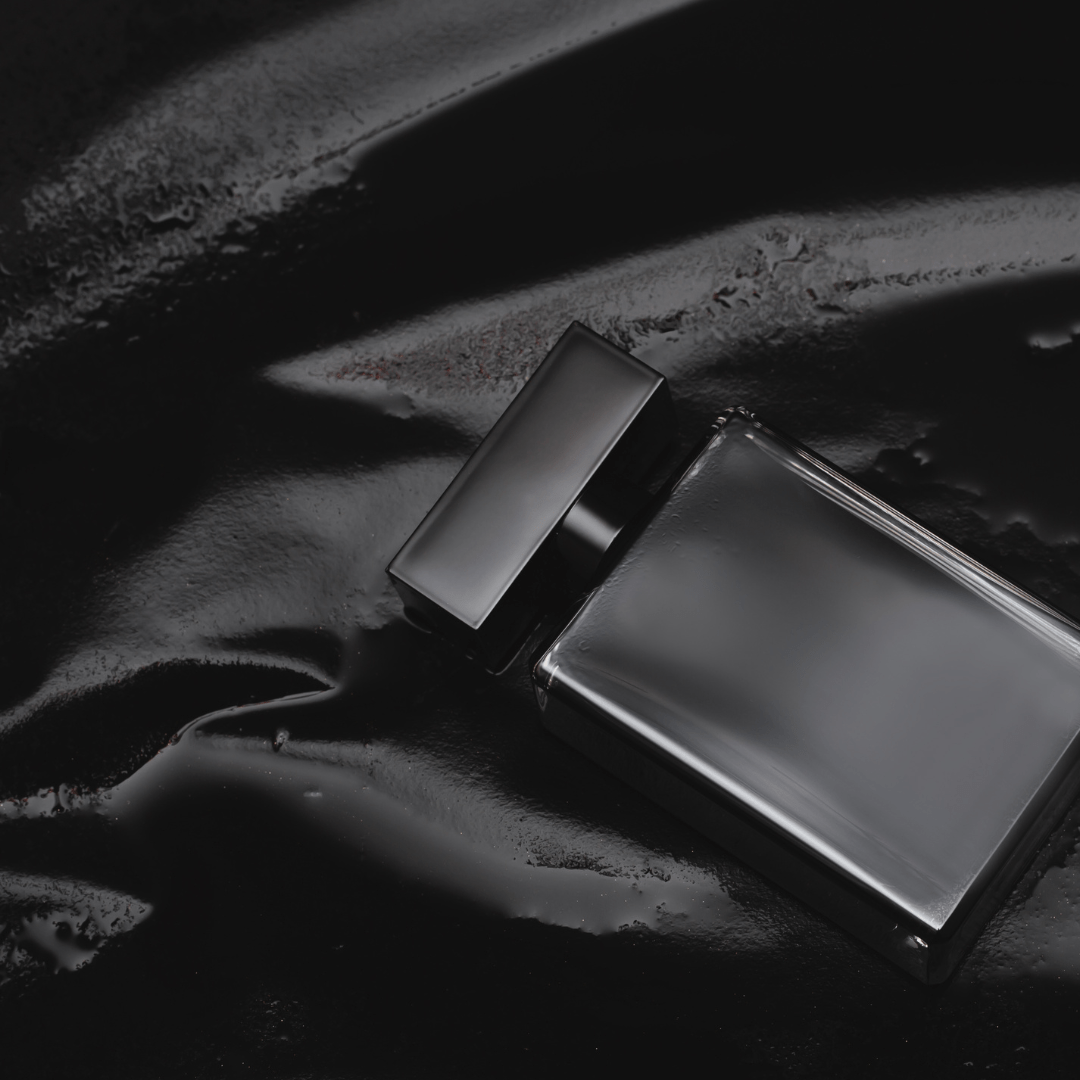 black perfume bottle on wet black background