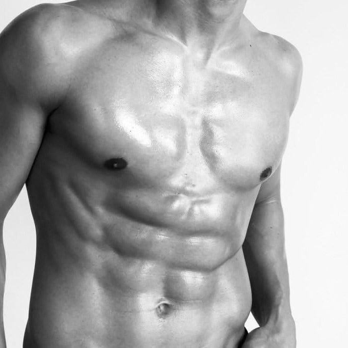 oiled male torso in black and white