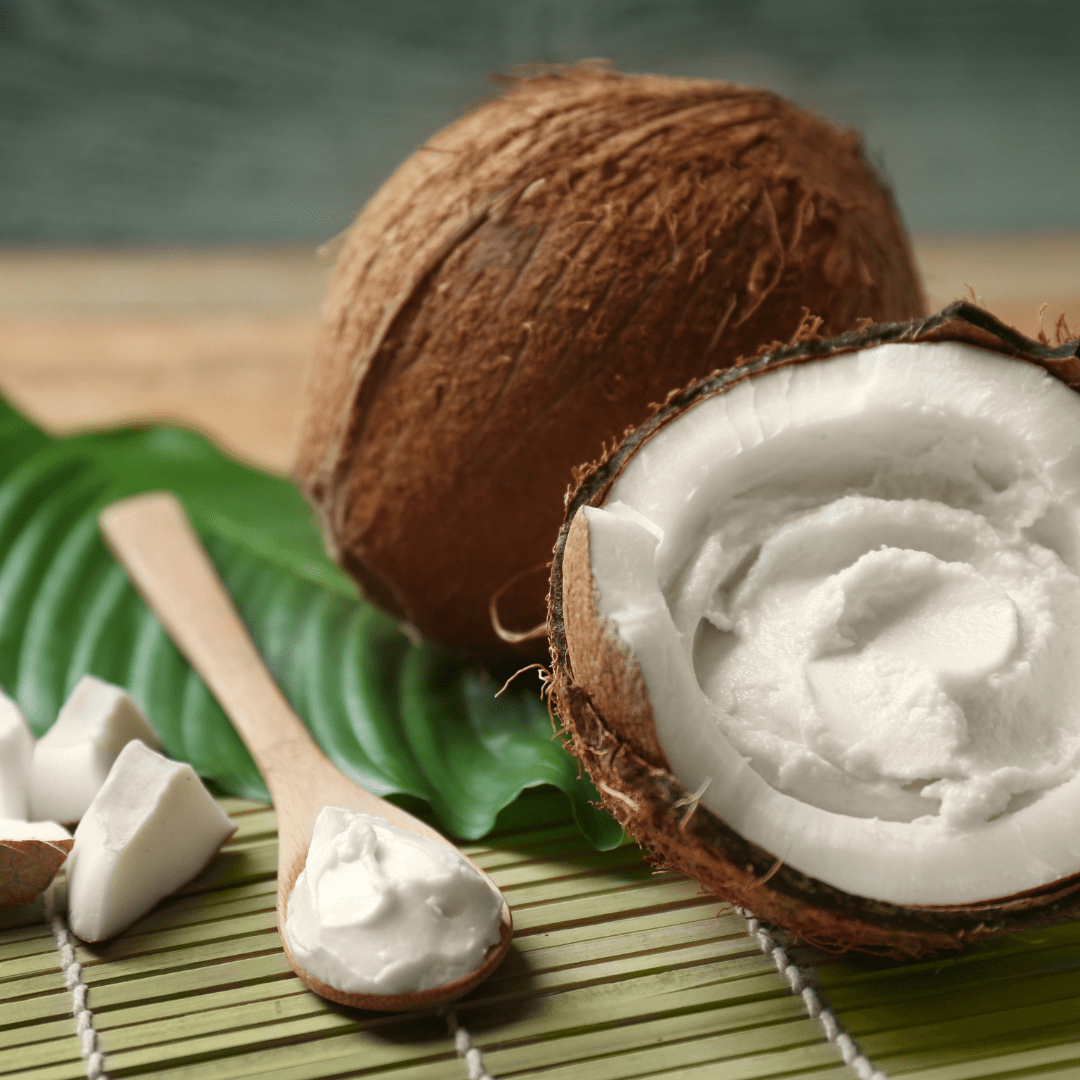 Coconut split with creamy centre and spoon resting to the side