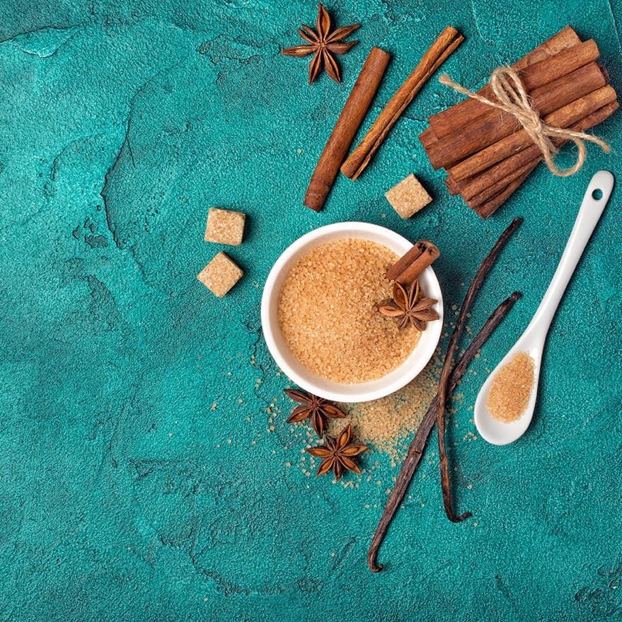 bowl of brown sugar with cinnamon sticks twined together