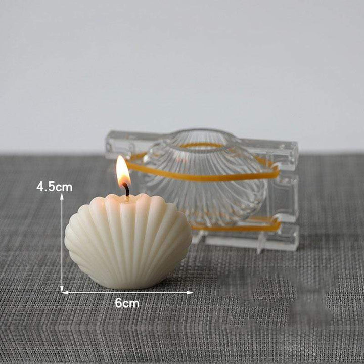 4.5cm high 6cm wide clam shell mould in creamy white colour with acrylic mould in background on grey textured table