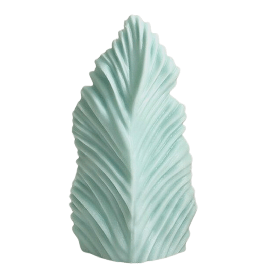fern leaf candle mould in aqua green coloured wax on white background