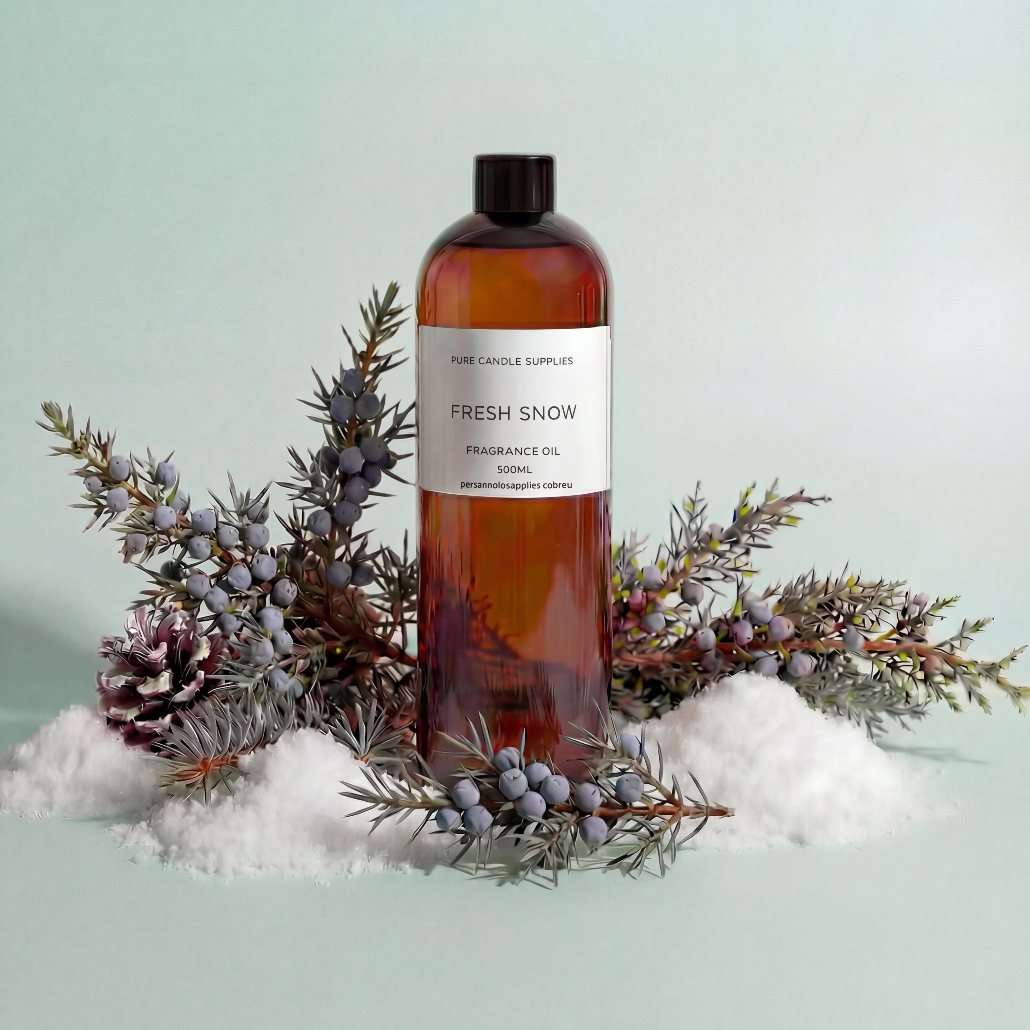 Bottle of 'Fresh Snow' fragrance oil with winter elements on a light green background