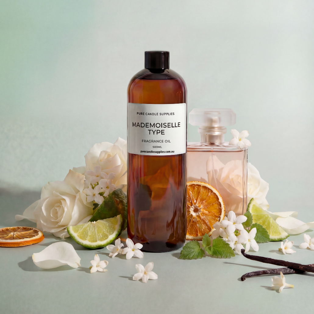 Bottle of Mademoiselle Type fragrance oil with flowers and citrus on a light background