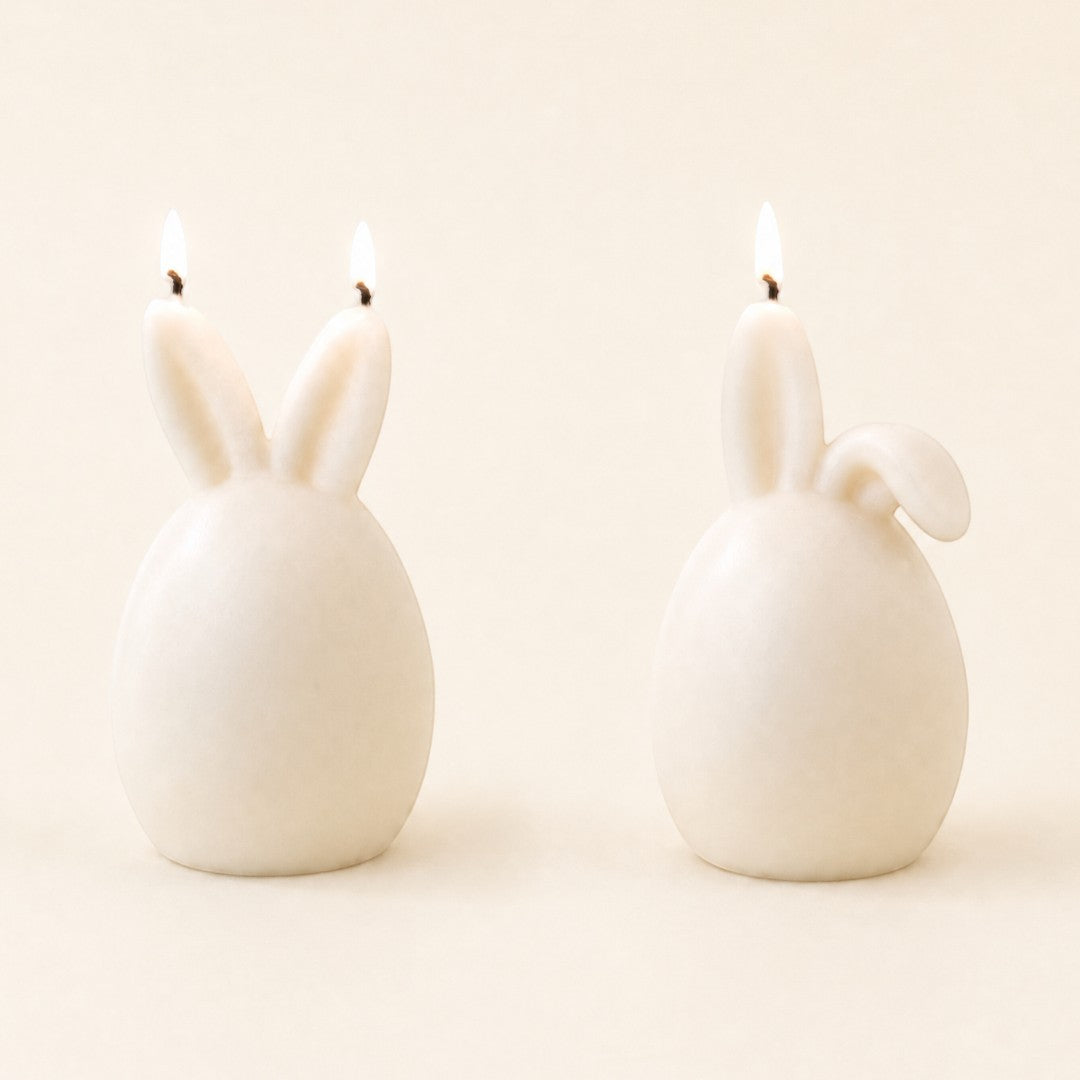 Pure Candle Supplies Melbourne bunny egg candles with lit wicks, one with both ears up and one with one ear down.