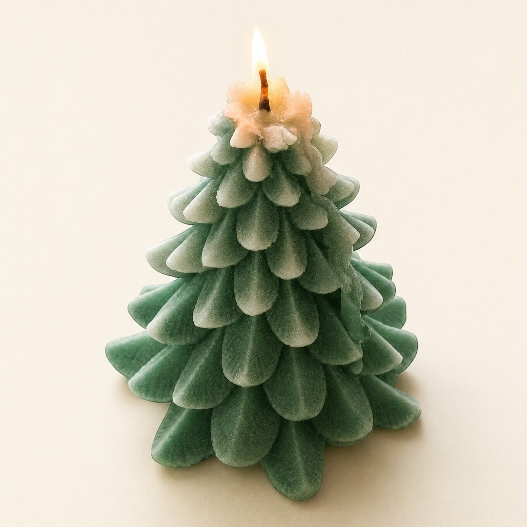 Pure Candle Supplies Melbourne flocked Christmas tree candle with green textured leaves and a lit wick