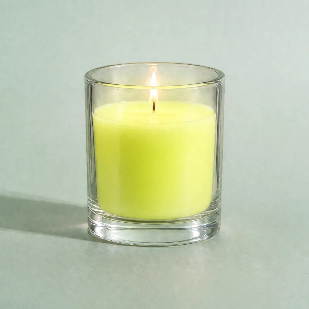 Pure Candle Supplies Melbourne fluro yellow candle dye chip result in a clear glass container with a lit wick