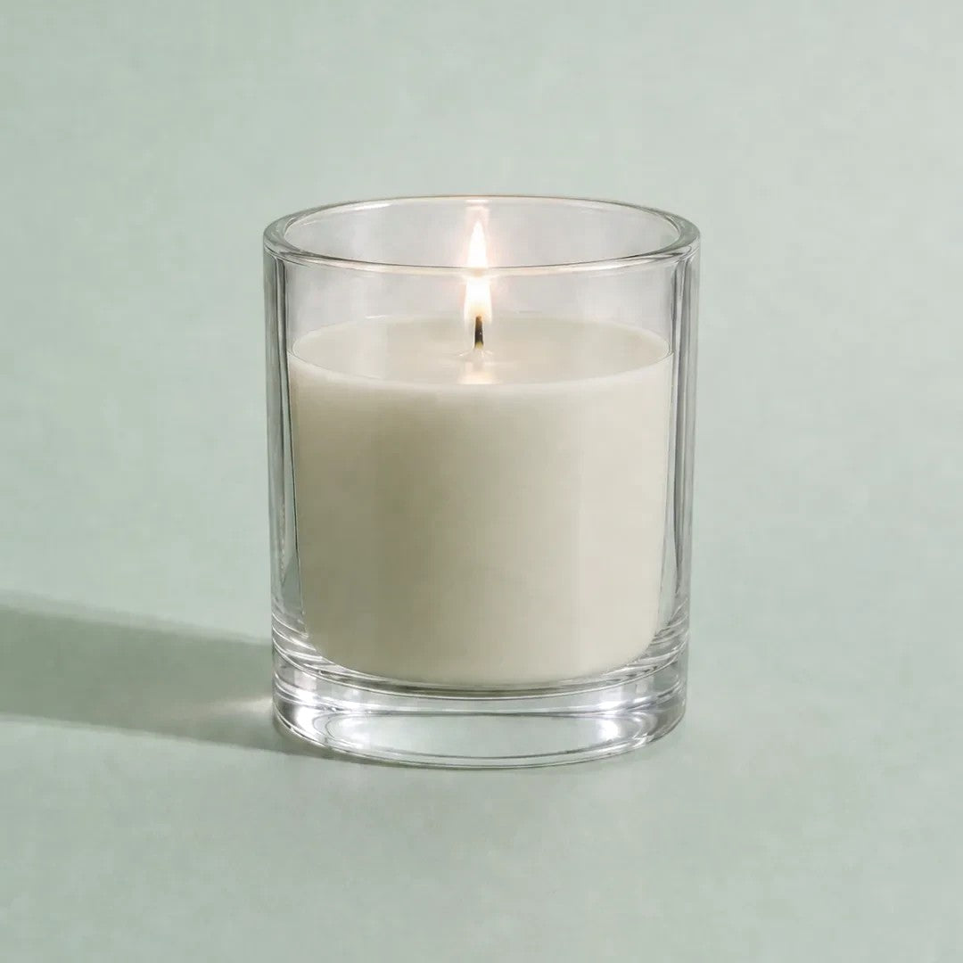 Pure Candle Supplies Melbourne pistachio coloured candle in a clear glass container with a lit wick