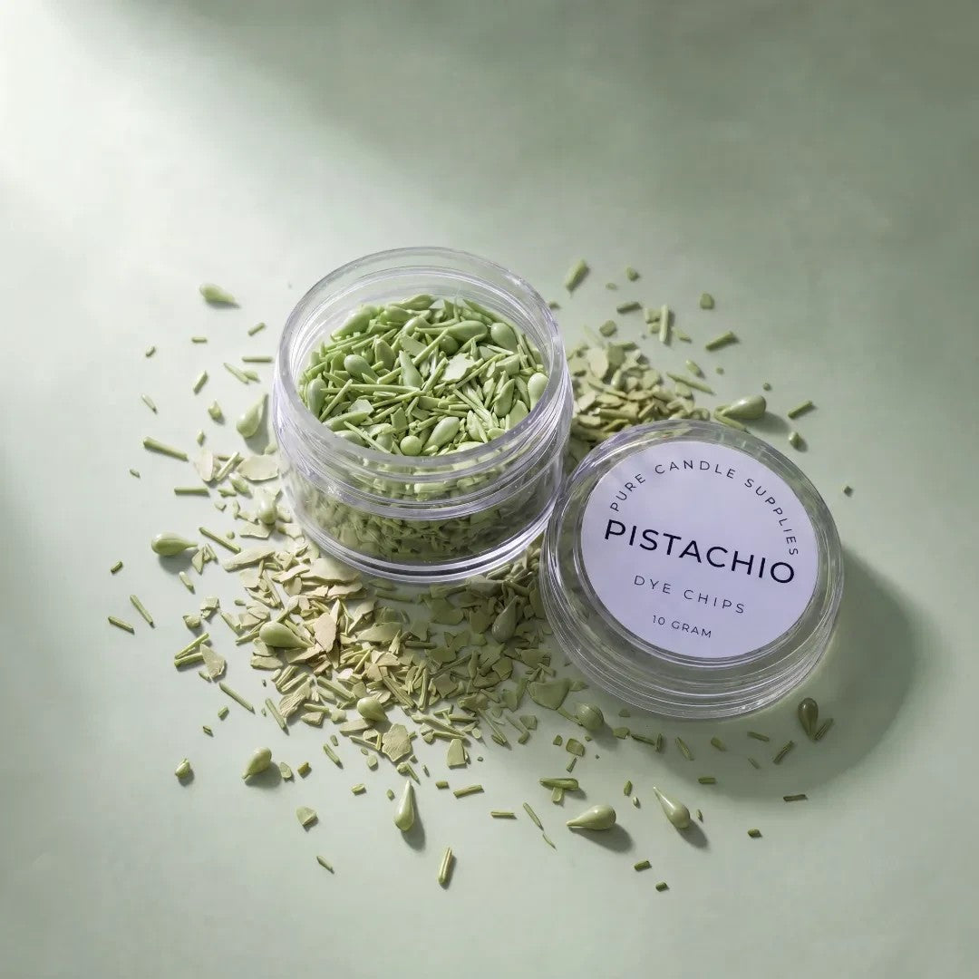 Pure Candle Supplies Melbourne pistachio green candle dye chips in a small clear jar on a matching green surface.