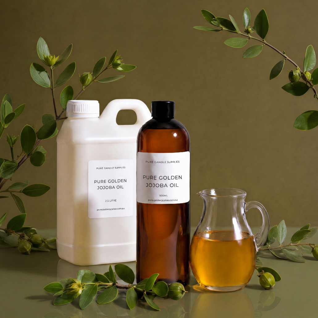Bottles of Pure Golden Jojoba Oil with a small pitcher on a green background