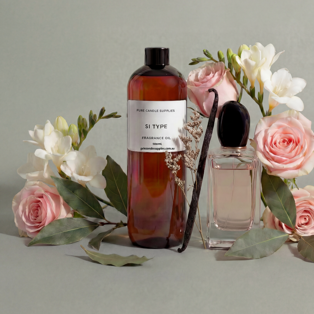 Two perfume bottles with floral arrangements on a light gray background