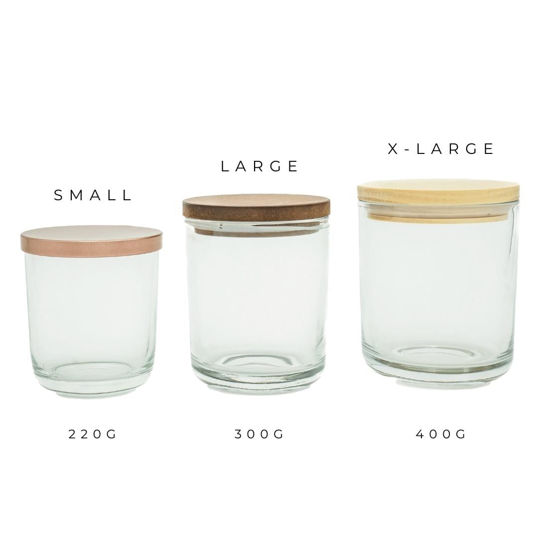 three clear sienna candle jars in small medium and large with a brushed rose gold lid walnut timber lid and pine timber lid in a row
