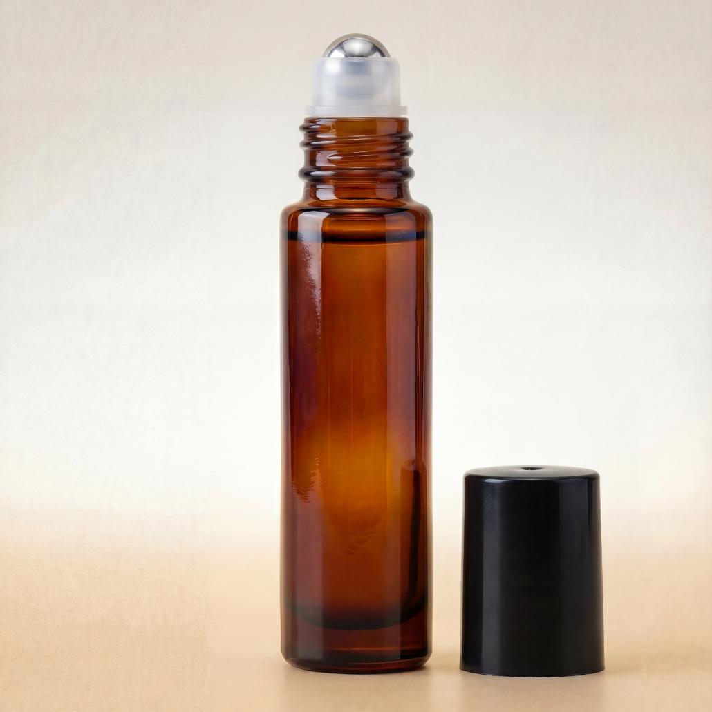 Amber glass roller bottle with silver cap on a beige background