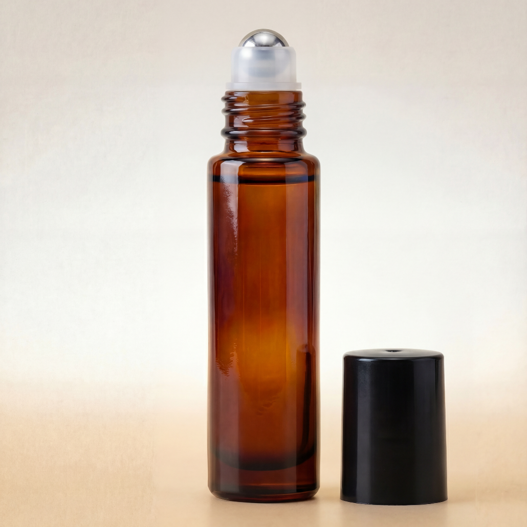 Amber glass roller bottle with silver cap on a beige background