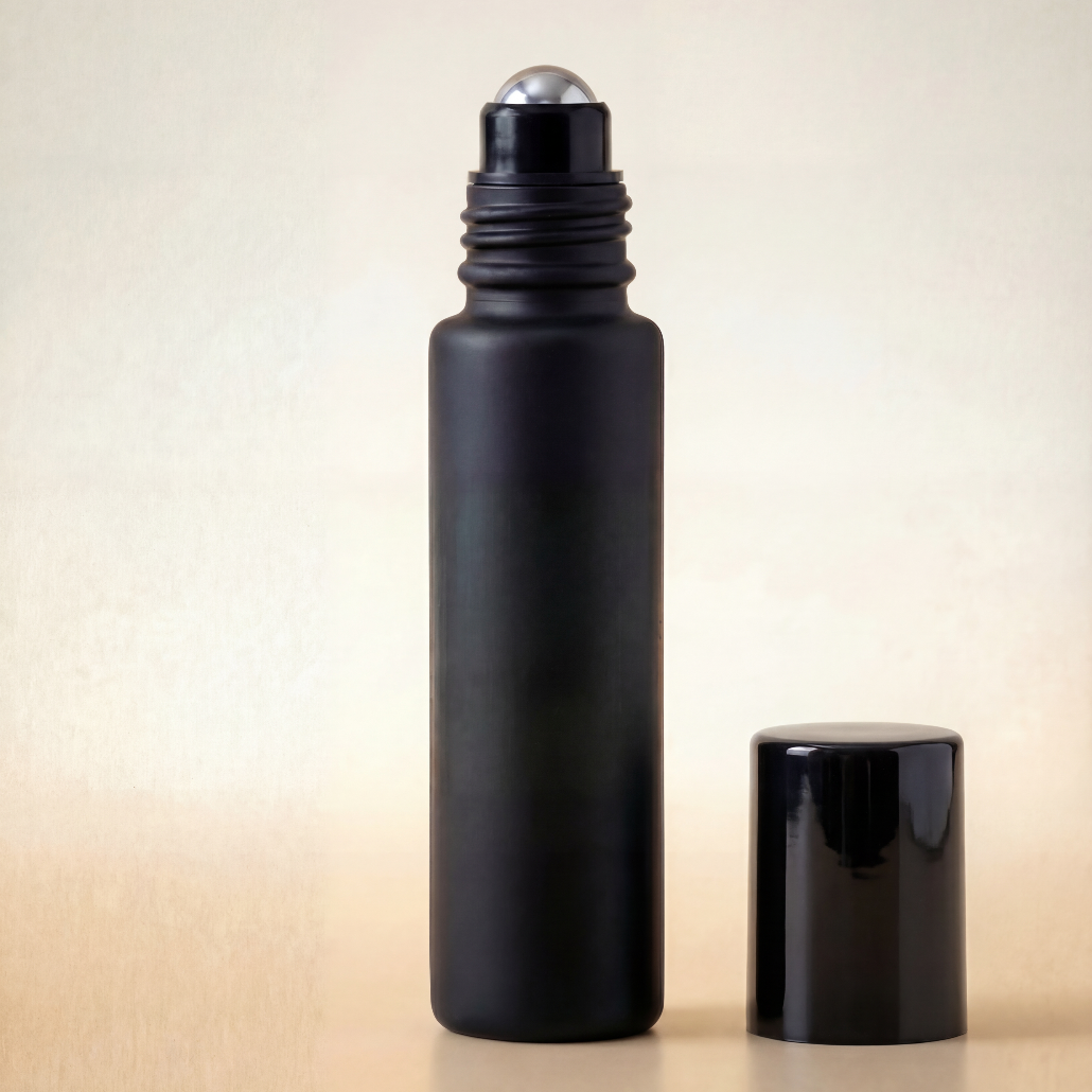 Black roller bottle with silver cap on a beige background