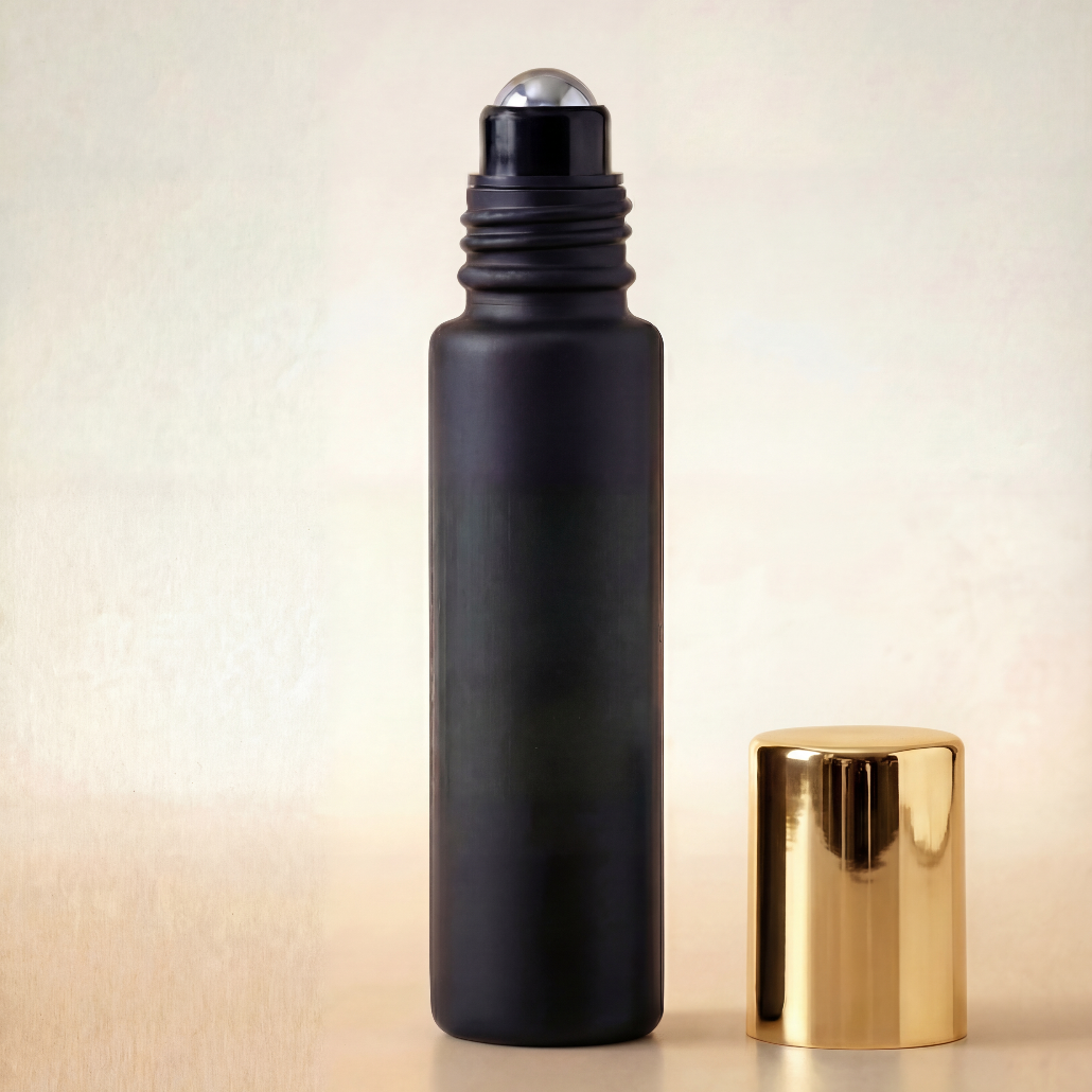 Black roller bottle with gold cap on a beige background