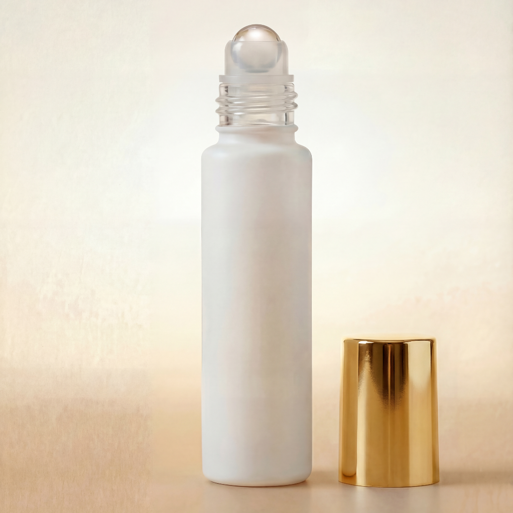 White rollerball bottle with gold cap on a beige background