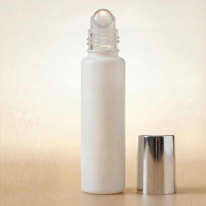 White roller bottle with silver cap on a beige background