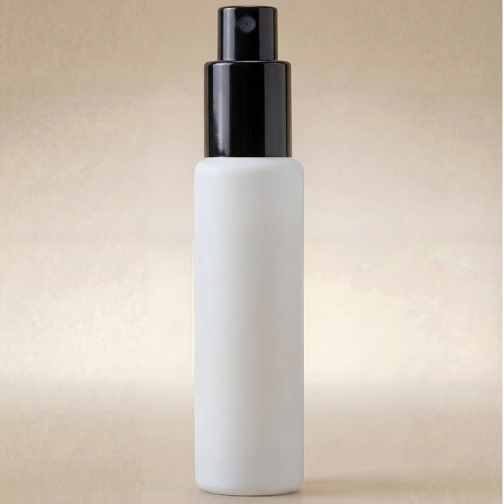 White spray bottle with black nozzle on a beige background