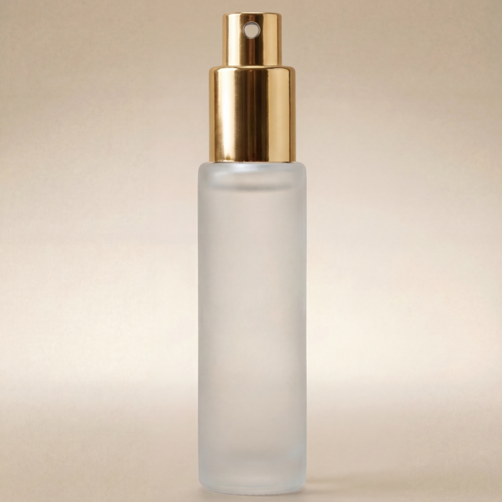 Frosted spray bottle with gold cap on a beige background
