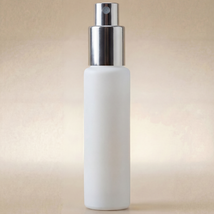 White spray bottle with silver nozzle on a beige background