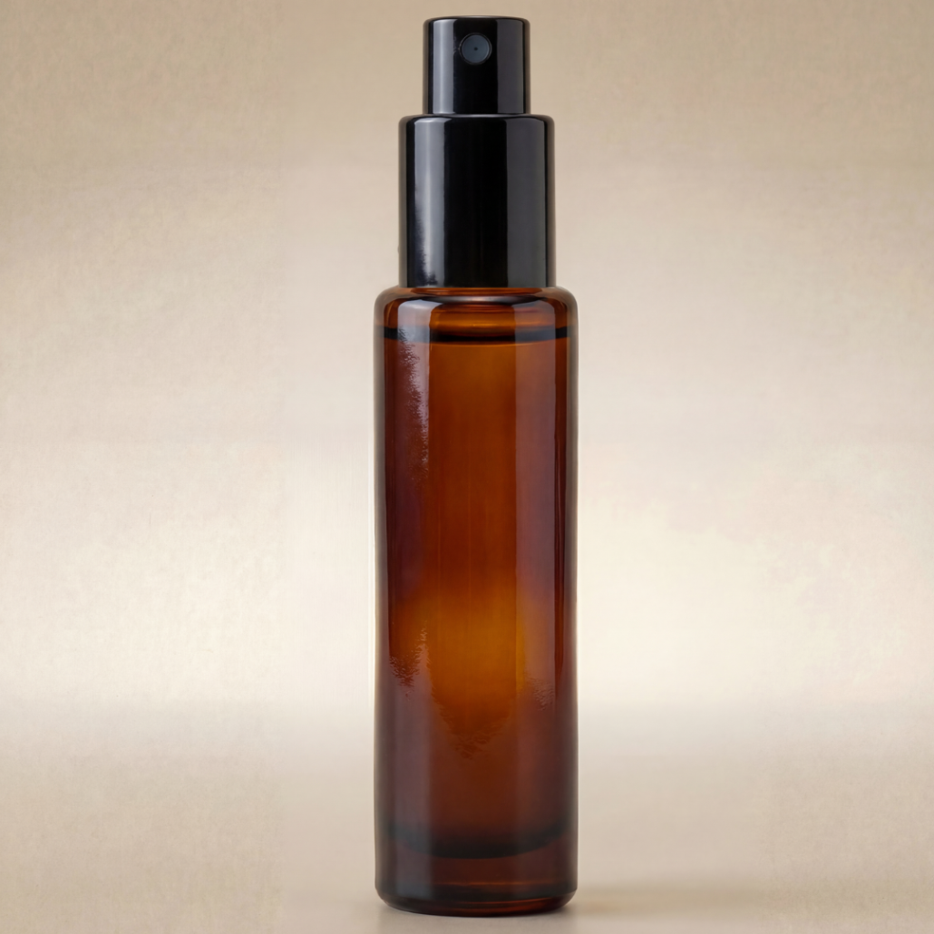 Amber glass spray bottle with black cap on a beige background
