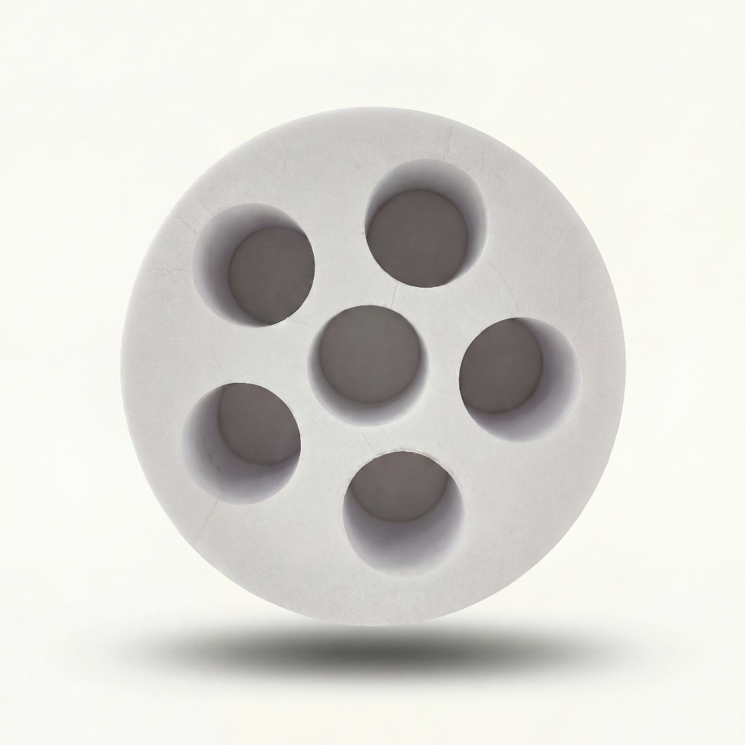 White foam insert with circular cavities on a white background