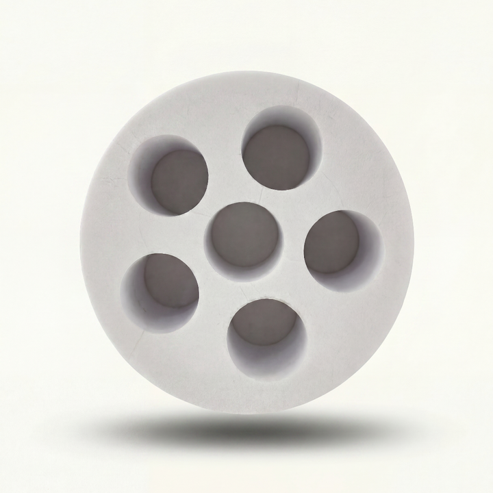 White foam insert with circular cavities on a white background
