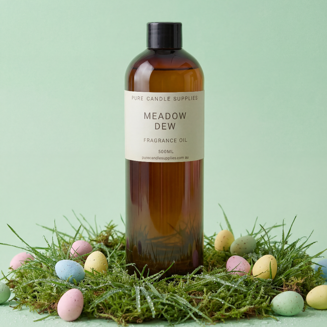 Bottle of 'Meadow Dew' fragrance oil with Easter eggs and grass on a light green background