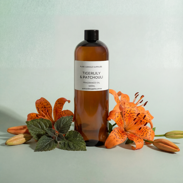 Bottle of Tigerlily & Patchouli oil with flowers on a light background