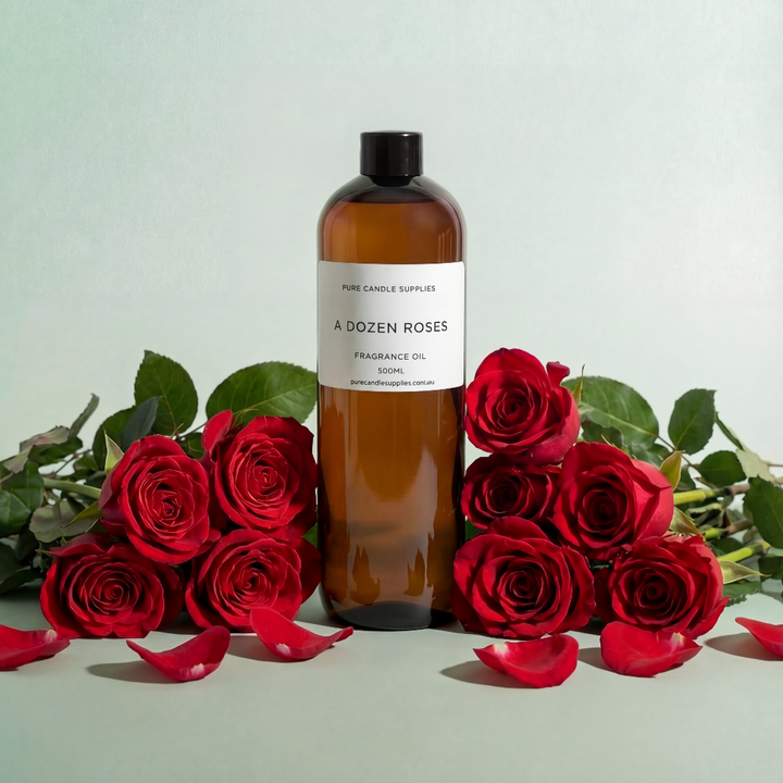 Bottle of 'A Dozen Roses' fragrance oil with red roses on a light background