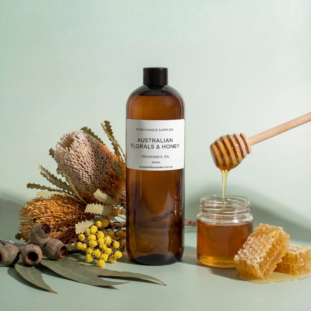 Bottle of Australian Florals & Honey fragrance oil with honeycomb and honey on a light green background