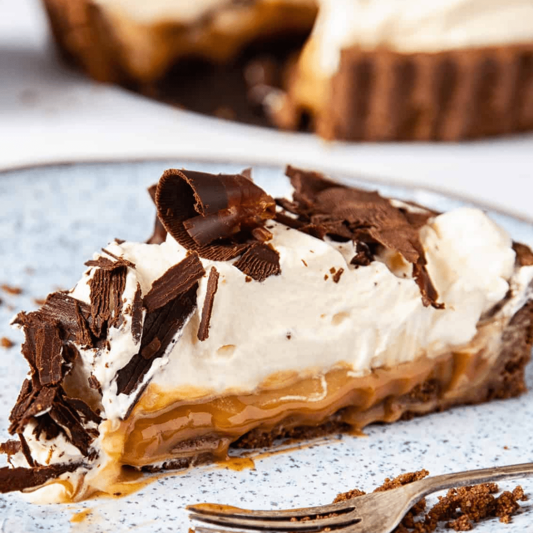 Piece of pie with toffee, whipped cream & dark chocolate shavings