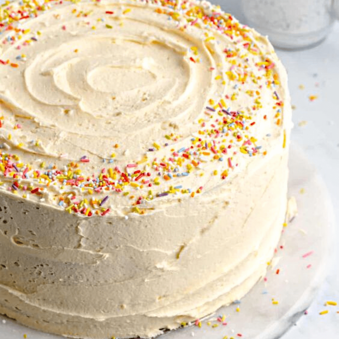 Birthday cake with white frosting and sprinkles