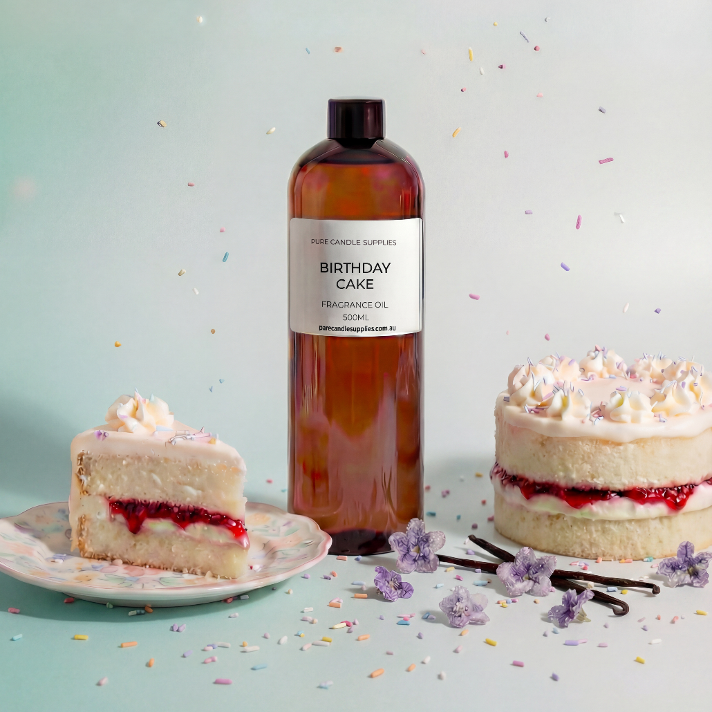 Bottle of 'Birthday Cake' fragrance oil with a slice of cake and a full cake on a light blue background.