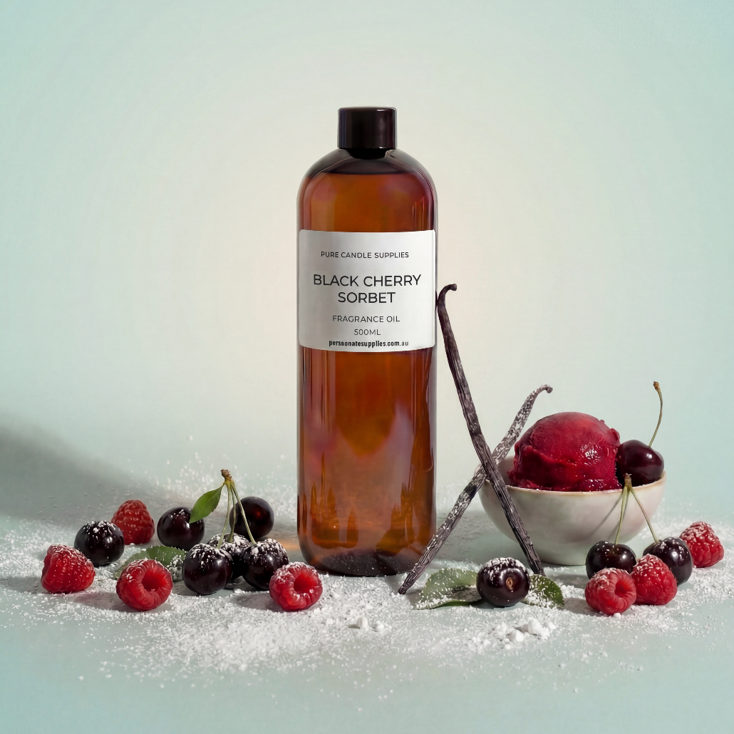 Bottle of 'Black Cherry Sorbet' fragrance oil with black cherries and raspberries on a light background
