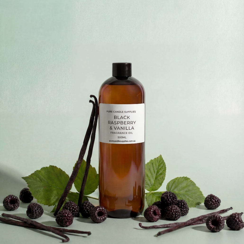 Bottle of Black Raspberry & Vanilla fragrance oil with vanilla beans and black raspberries on a light background