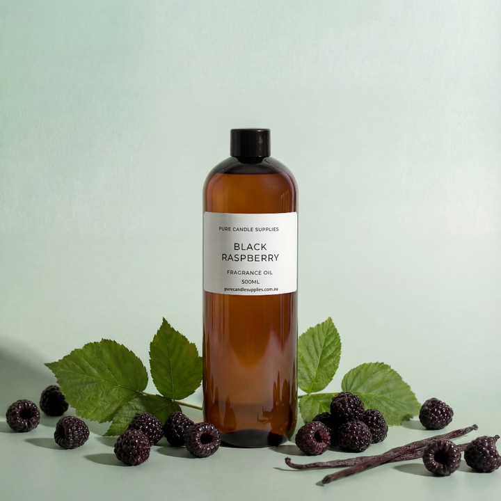 Bottle of Black Raspberry fragrance oil with blackberries and leaves on a light green background