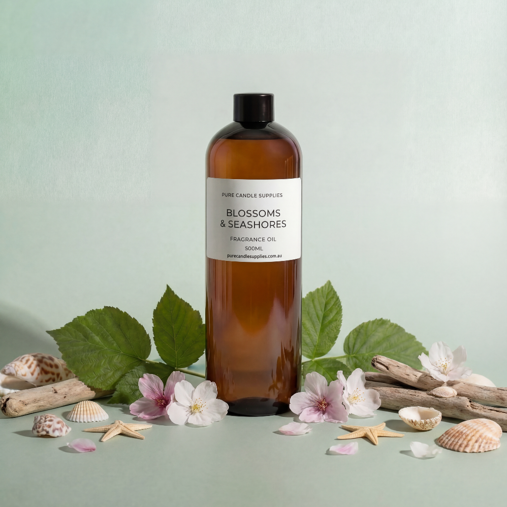 Bottle of Blossoms & Seashores fragrance oil with natural elements on a light green background