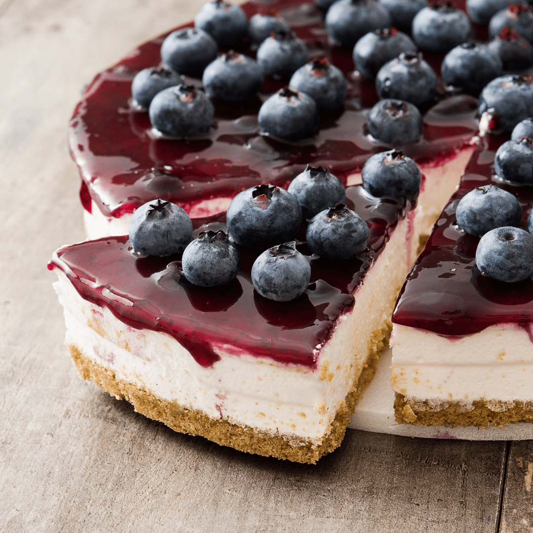 Blueberry cheesecake with fresh blueberries, syrup, cream cheese & biscuit base