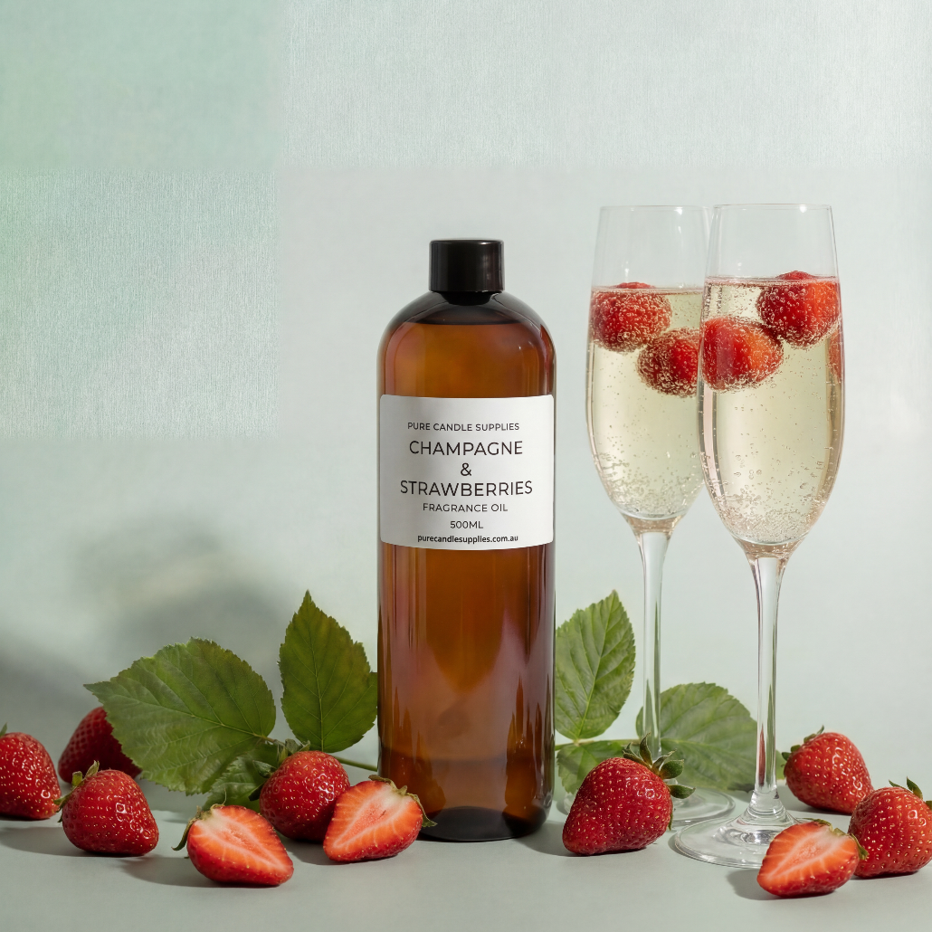Bottle of 'Champagne & Strawberries' fragrance oil with two champagne flutes and strawberries on a light background