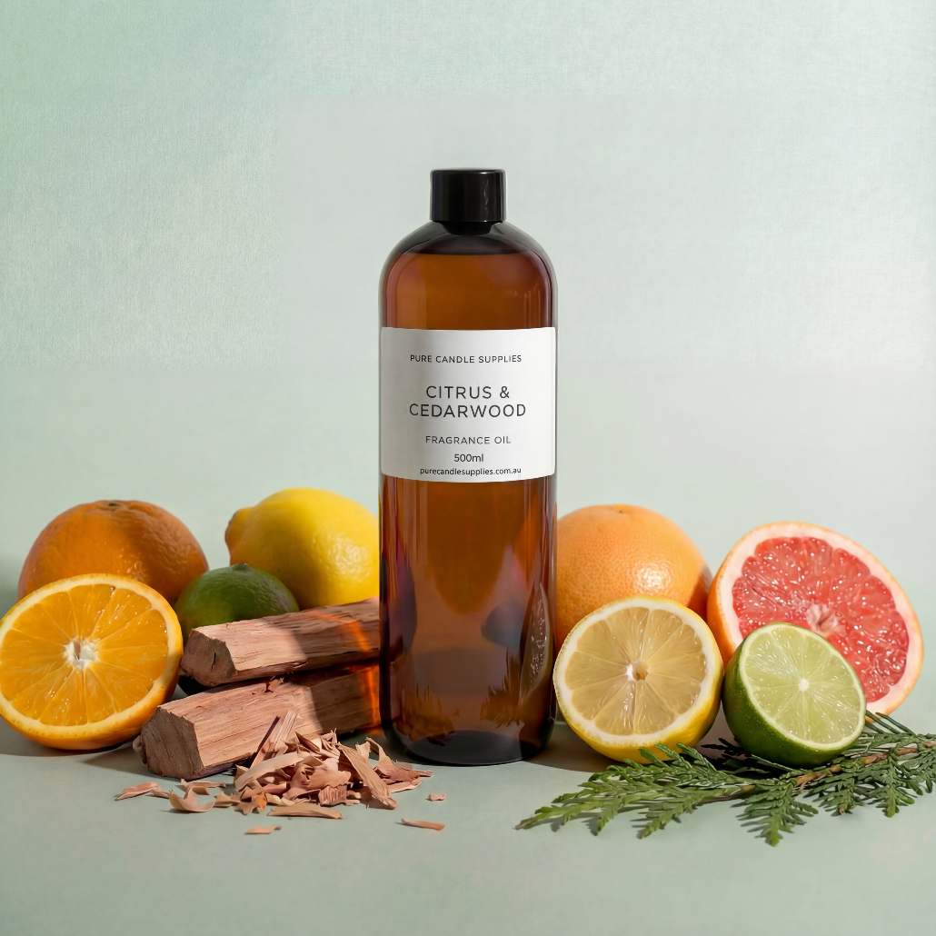 Bottle of Citrus & Cedarwood fragrance oil with citrus fruits and wood chips on a light green background