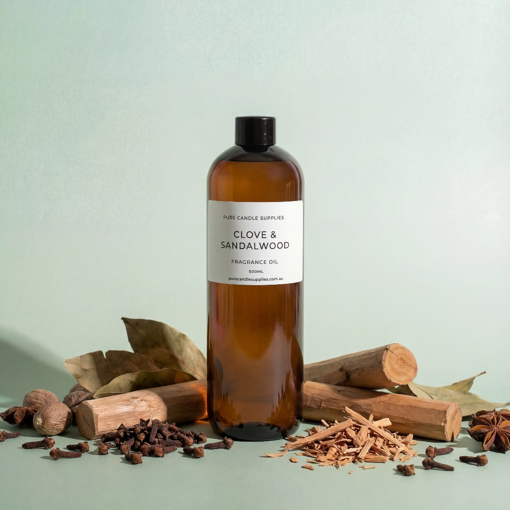 Brown bottle of clove and sandalwood fragrance oil with natural elements on a light green background