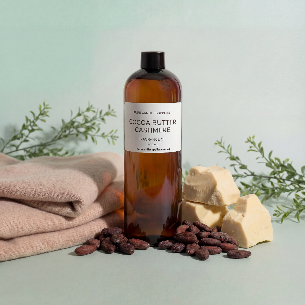Bottle of Cocoa Butter Cashmere fragrance oil with cocoa beans and a towel on a light green background