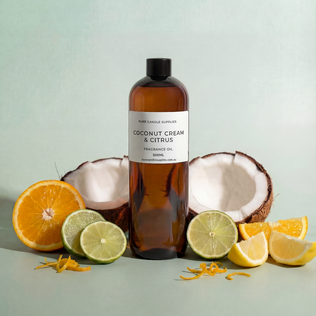 Bottle of coconut cream and citrus fragrance oil with coconuts, oranges, and limes on a light background