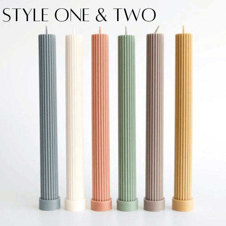 column pillar candles in various colours standing in a row on a white background