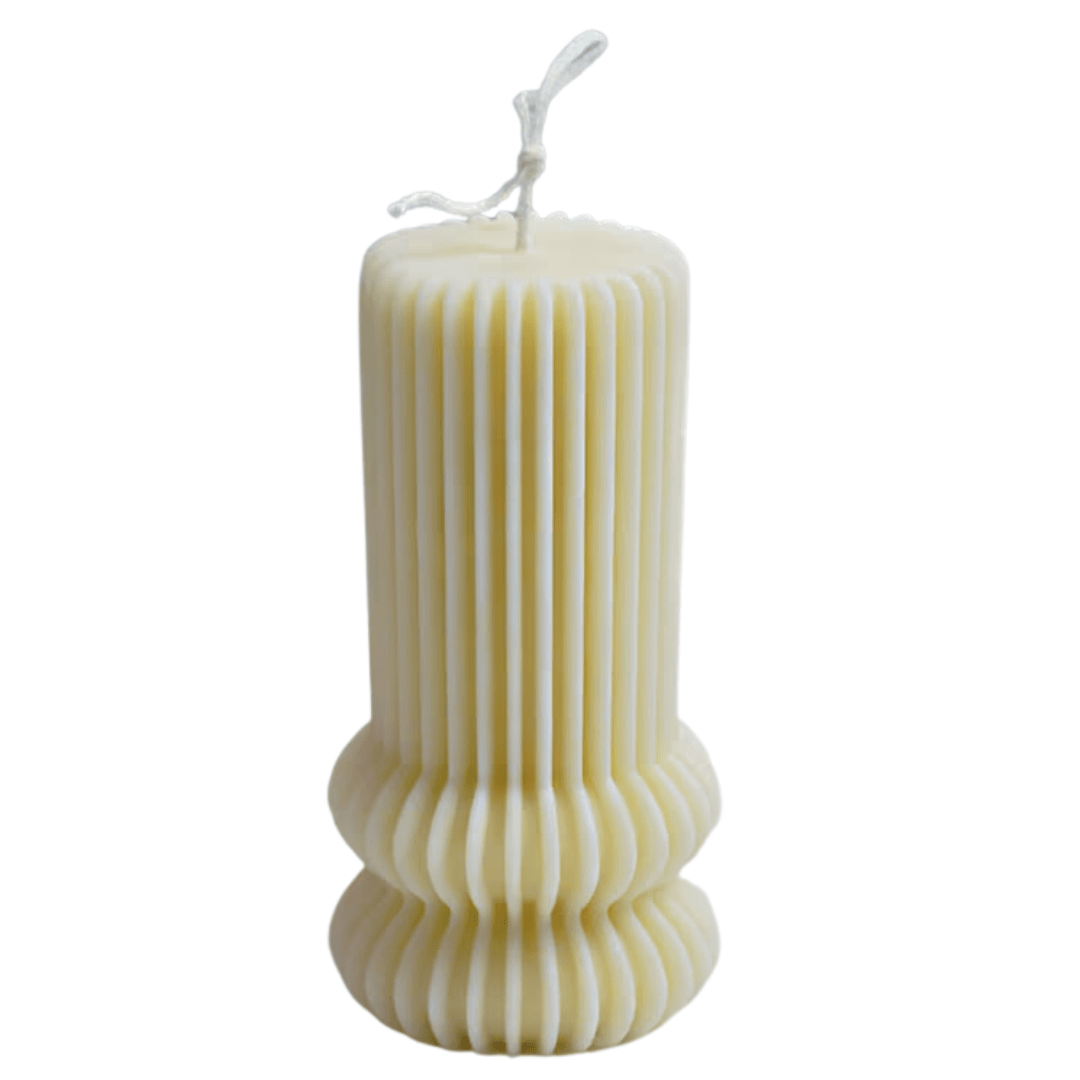 contemporary pillar candle with ribbed design in creamy white on a white background