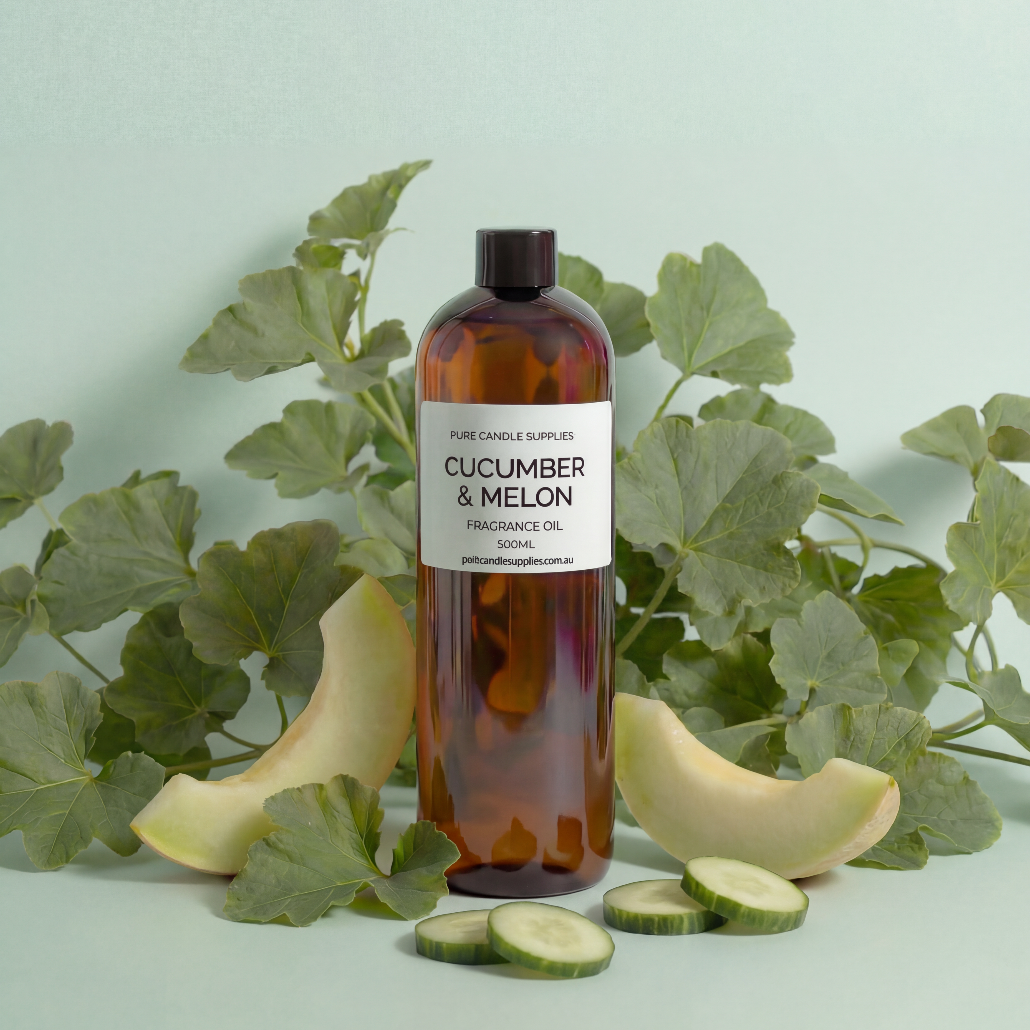 Bottle of cucumber and melon fragrance oil with cucumbers and leaves on a light green background